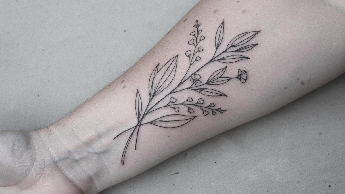 Healed fine line botanical tattoo on the inner forearm, photographed six weeks after the second session